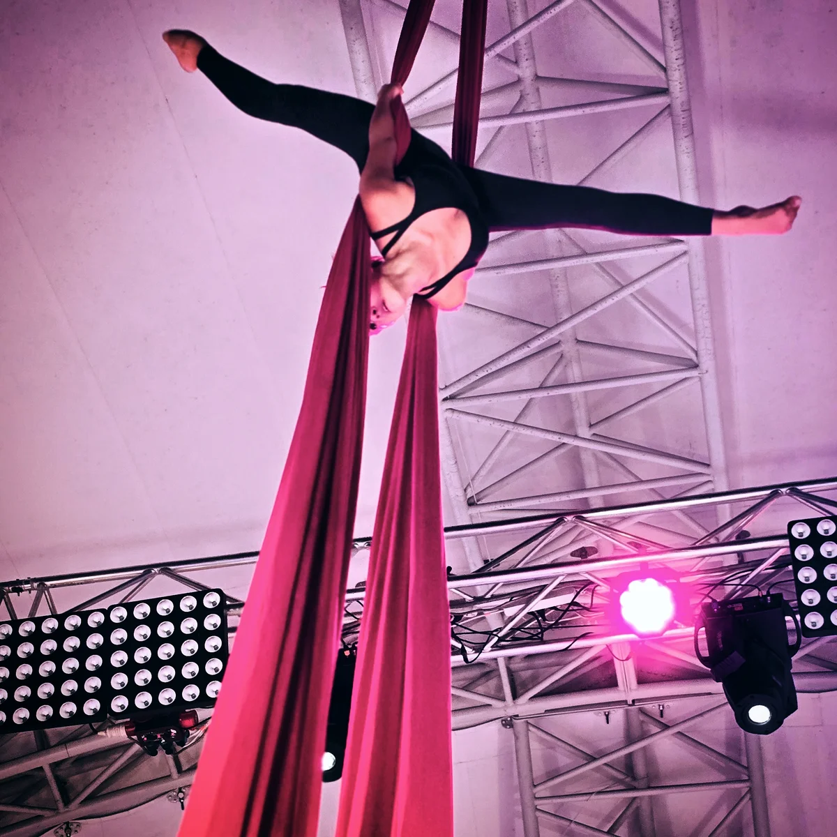 Silhouette wrapped in silks against stage light